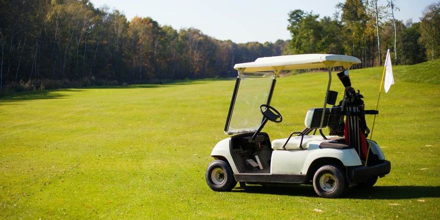 Image of a golf cart situated on a golf course